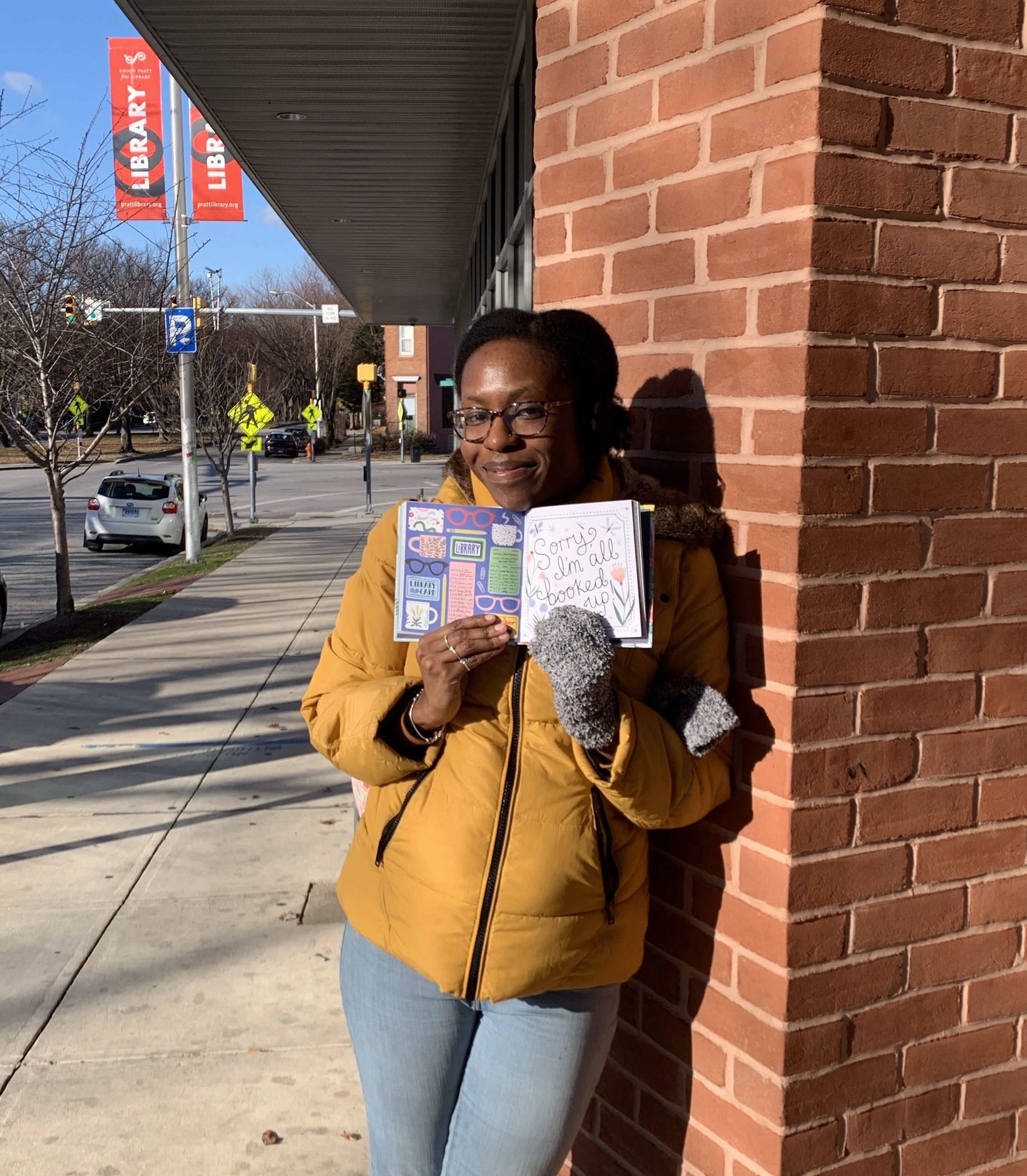 Woman with a book outside of a library